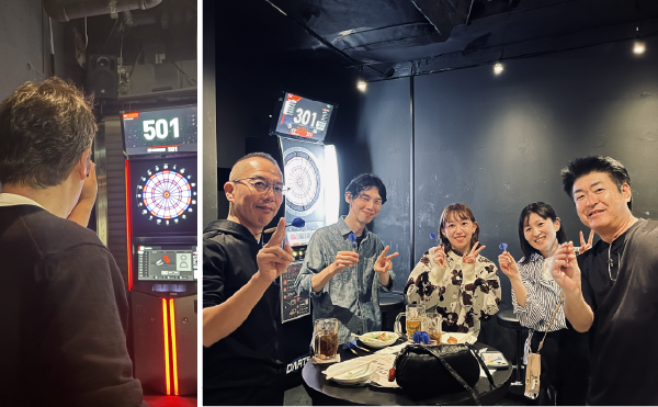 ダーツを持って笑顔でピース写真する社員と職人さんたち